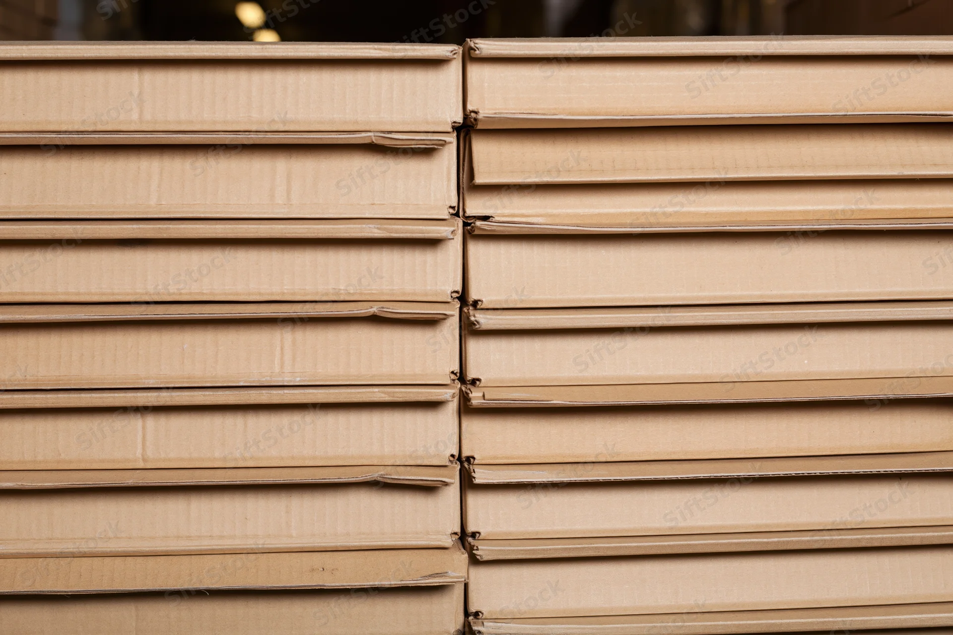 Stacked rows of identical sealed cardboard shipping boxes in a warehouse setting