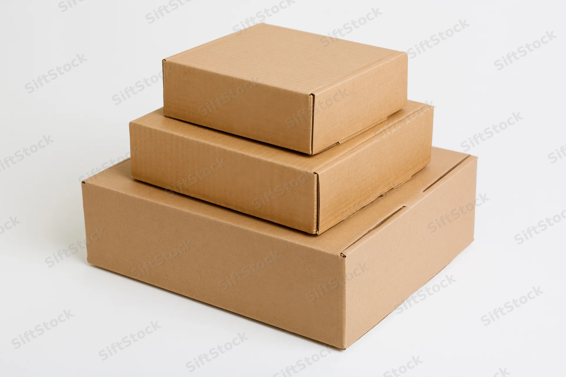 Three plain brown cardboard shipping boxes stacked in descending size on a white background