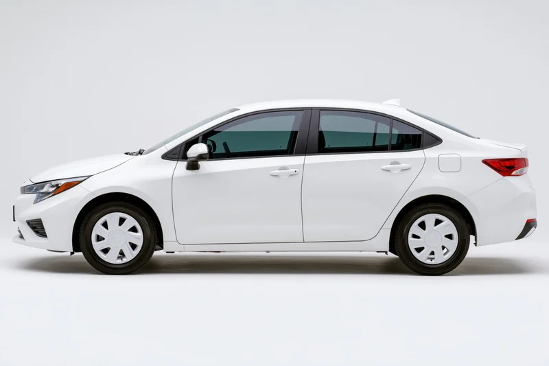 White compact sedan shown in profile view against a plain white background