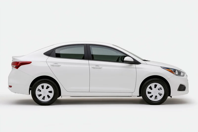 White compact sedan shown in side profile view against a plain white background