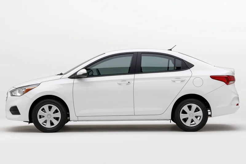 White compact sedan shown in profile view against a plain white background
