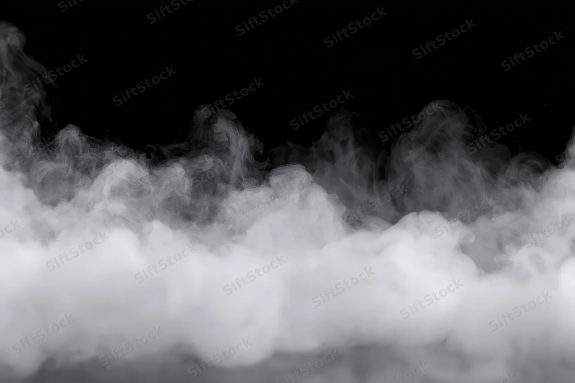 White smoke and mist drifting along the bottom and sides against a black background