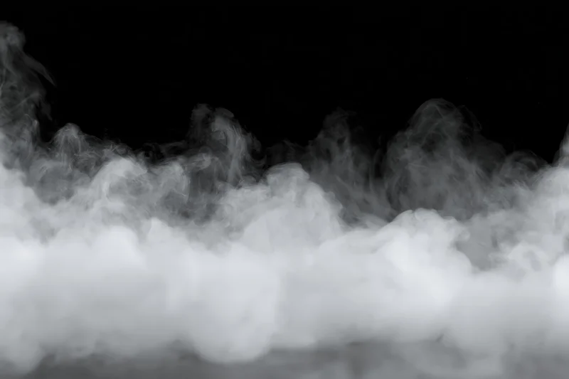 White smoke and mist drifting along the bottom and sides against a black background
