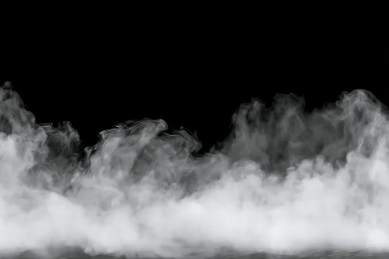 White smoke and mist drifting along the bottom and sides against a black background
