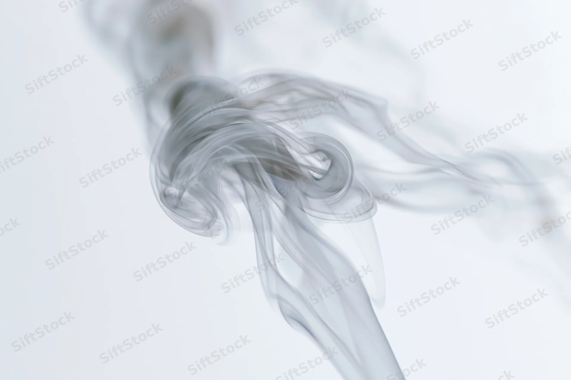 Wispy smoke curling and dispersing in mid-air against a pure white background