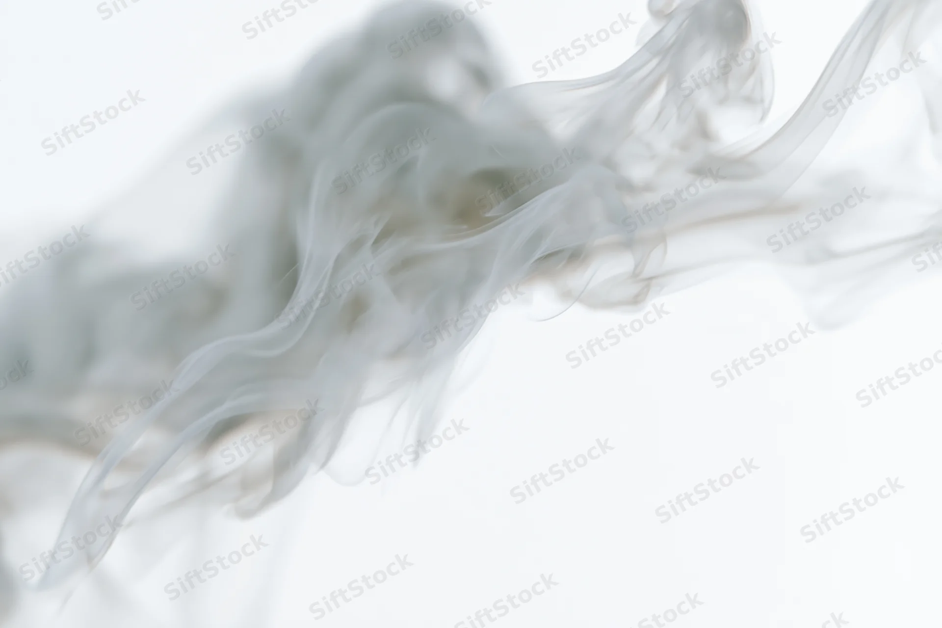 Wispy smoke curling and dispersing in mid-air against a pure white background