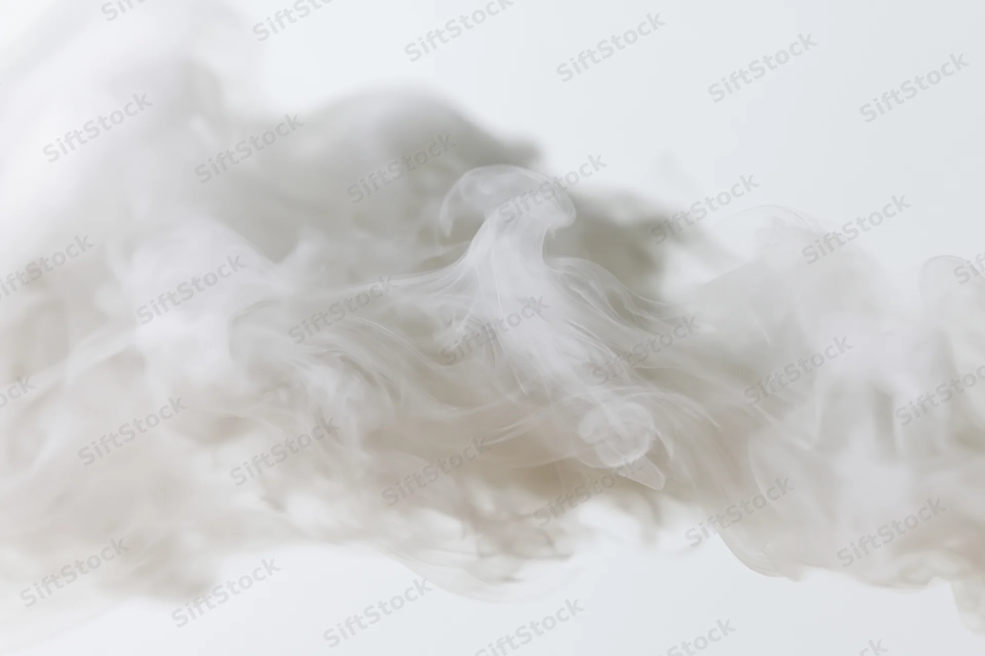 Wispy white smoke drifting and dispersing against a plain white background