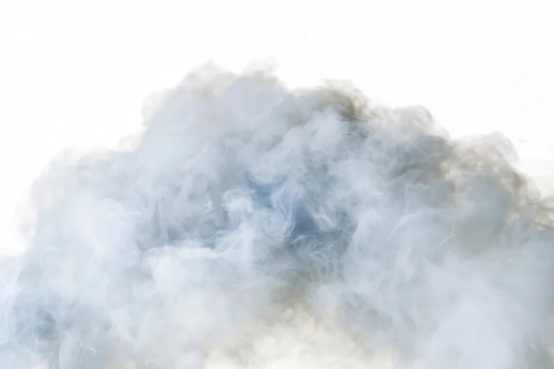 Wispy white smoke drifting and dispersing against a pure white background