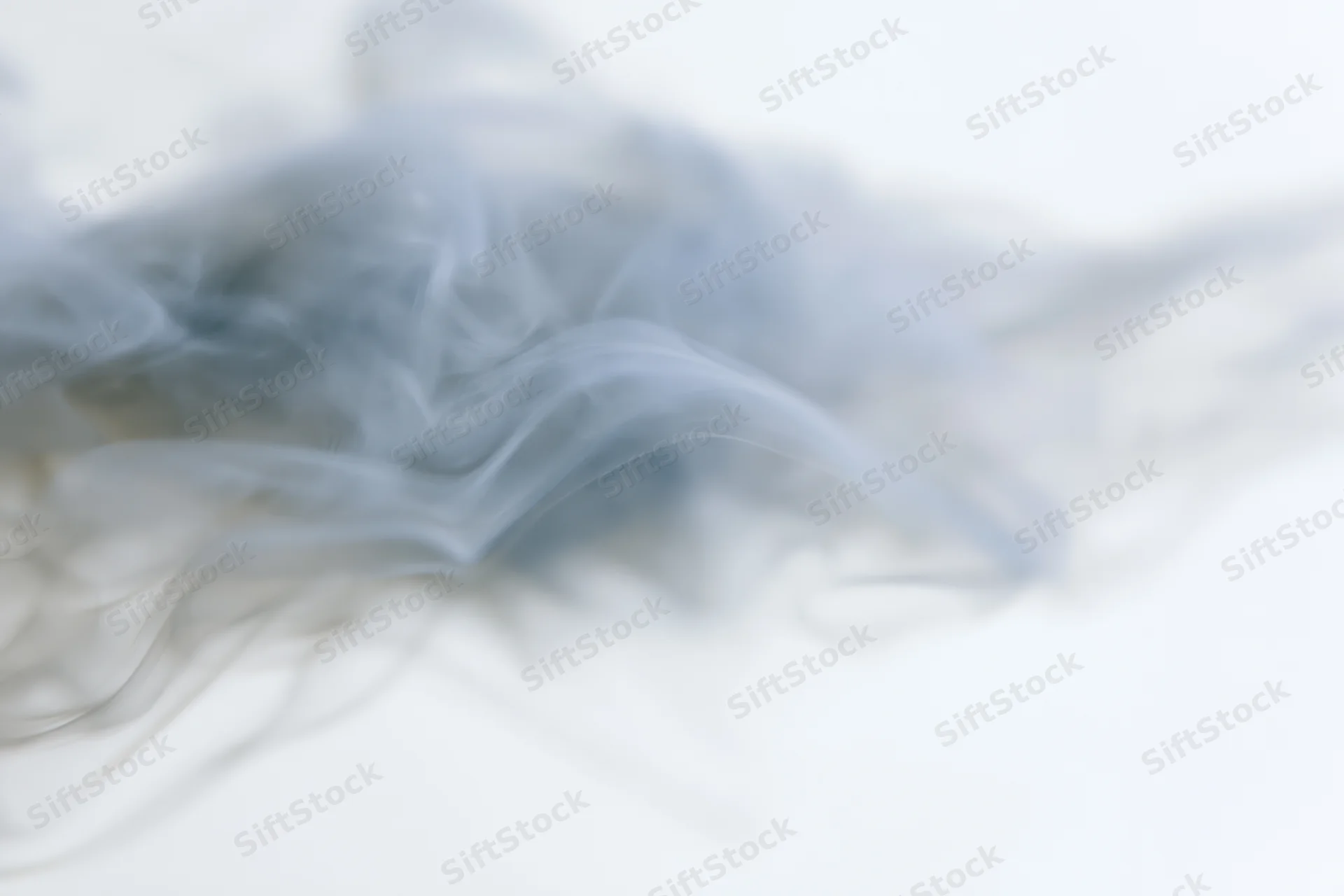 Wispy white smoke drifting and dispersing against a pure white background