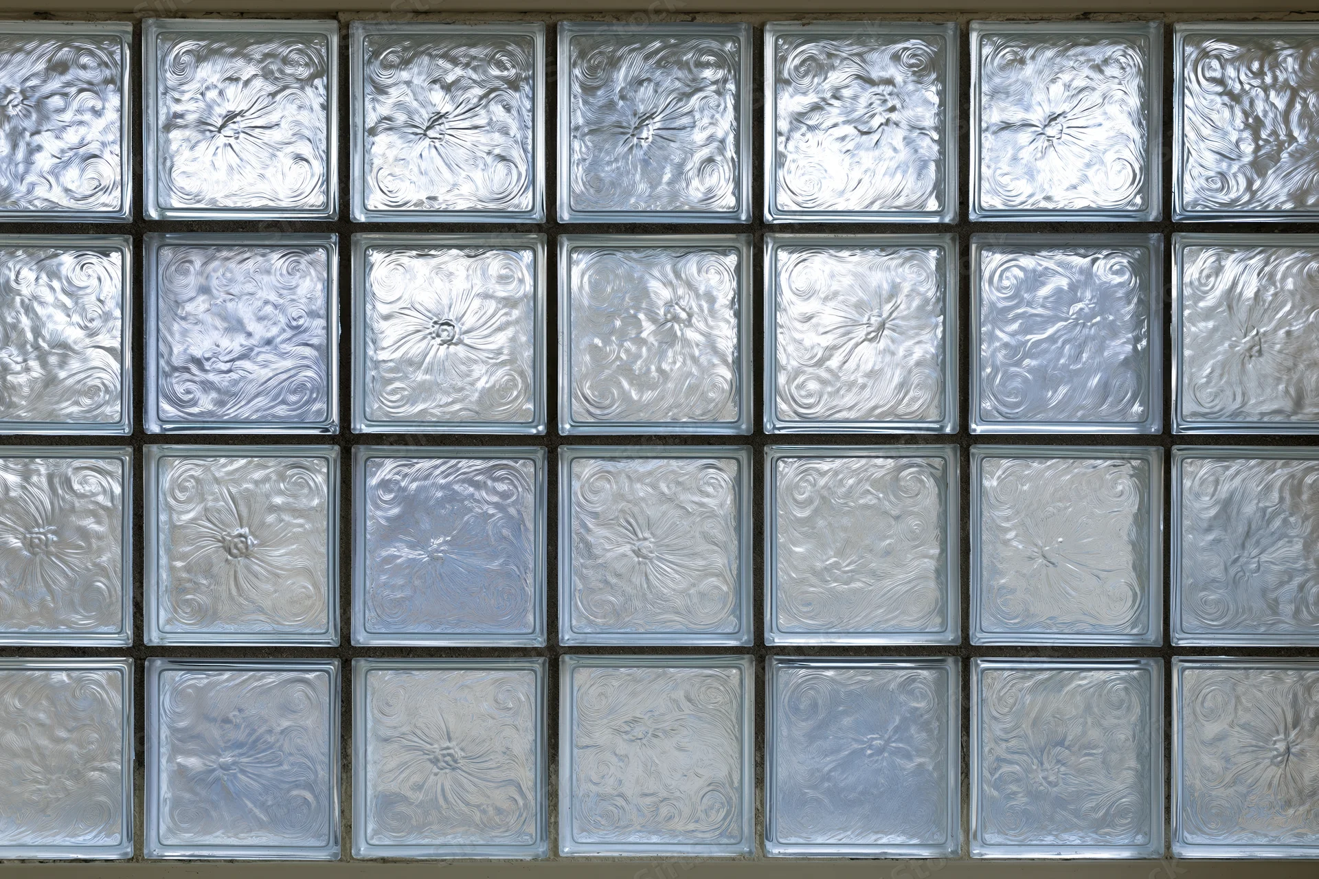 Square glass blocks arranged in a grid forming a textured wall