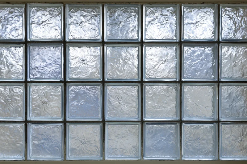 Square glass blocks arranged in a grid forming a textured wall