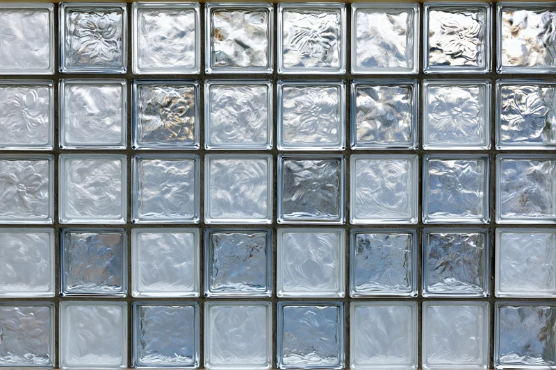 Flat wall of square glass blocks arranged in a grid pattern