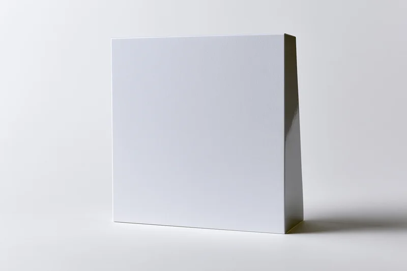 Blank white rectangular card standing vertically on a plain surface
