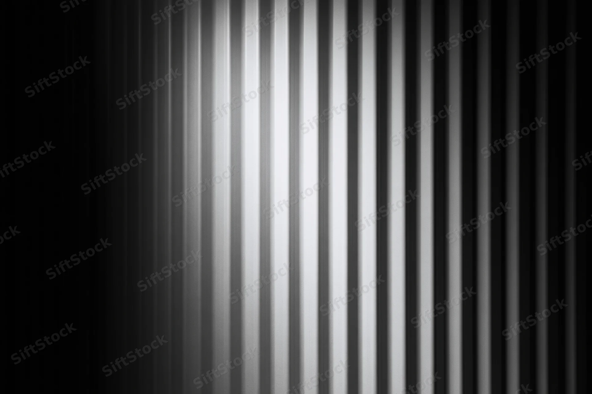 Close-up of a corrugated metal surface with vertical ribs and gray tonal gradient