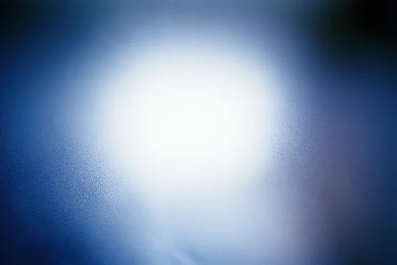 Frosted glass surface with diffused light creating soft blue and white glow