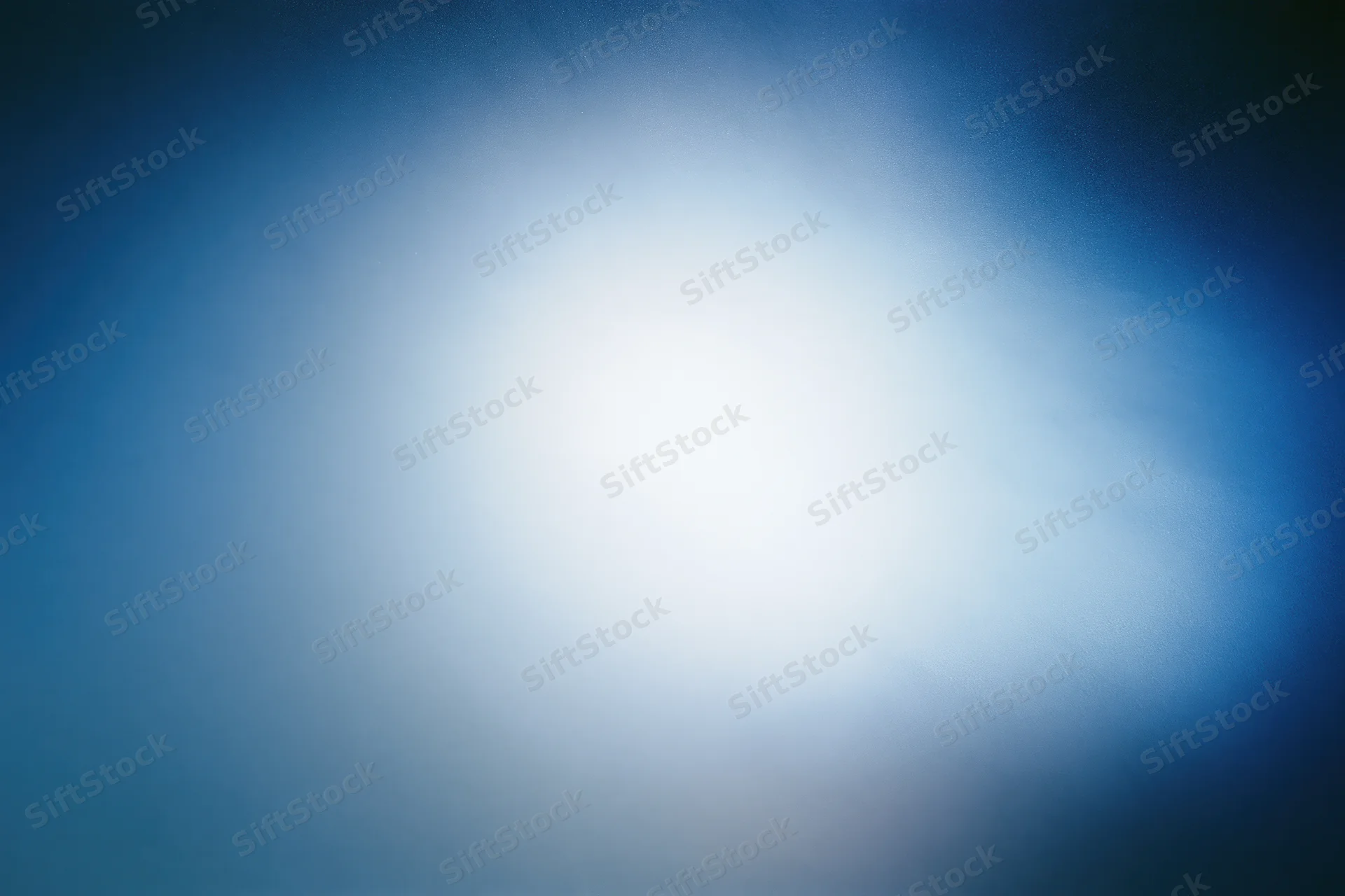 Diffused light passing through frosted glass surface creating soft blue-white gradient background