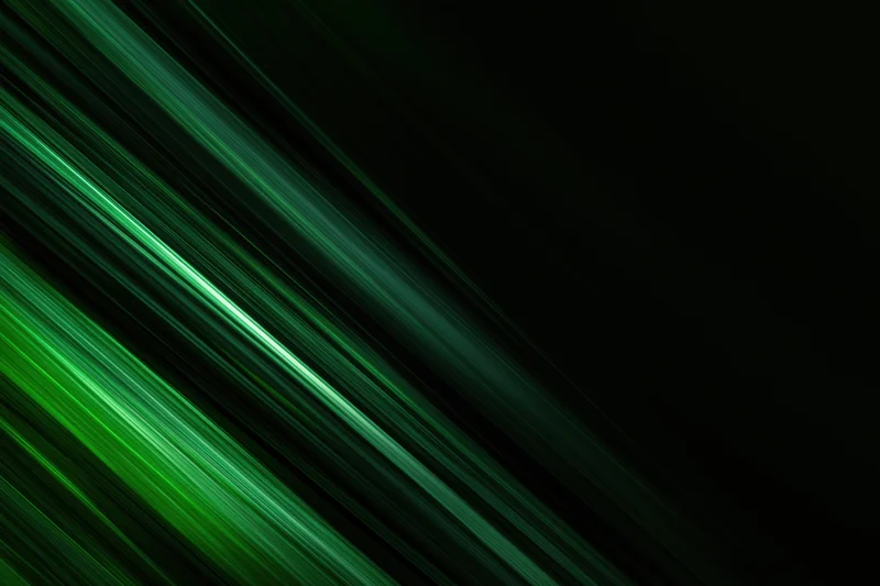 Diagonal green light streaks in motion blur against dark background with copyspace