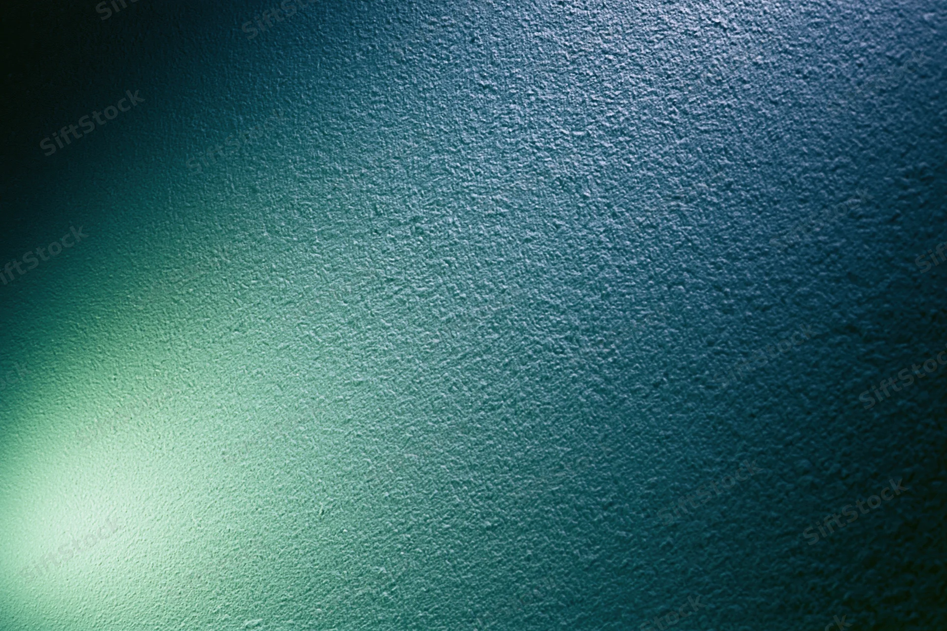 Abstract textured surface with soft glowing green light gradient