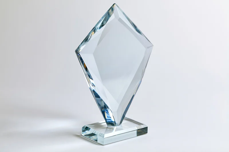 Blank crystal glass award trophy standing upright on a small base against a white background