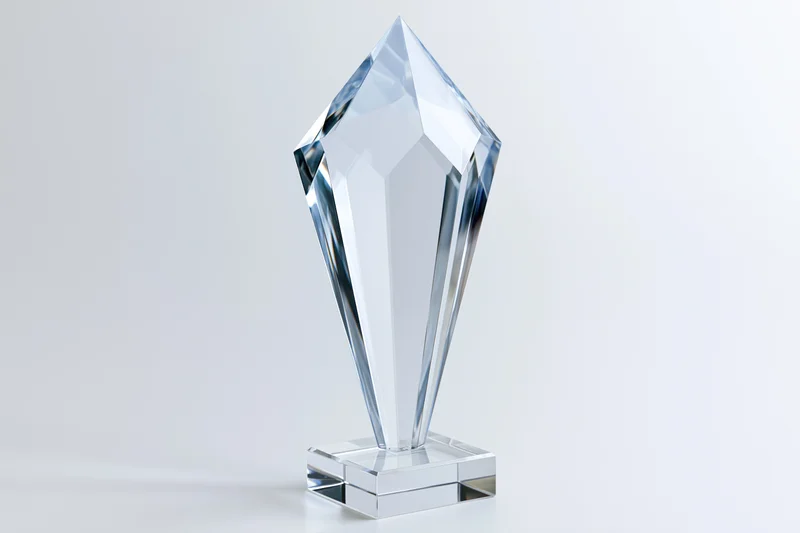 Crystal award trophy standing upright on a small glass base against a white background