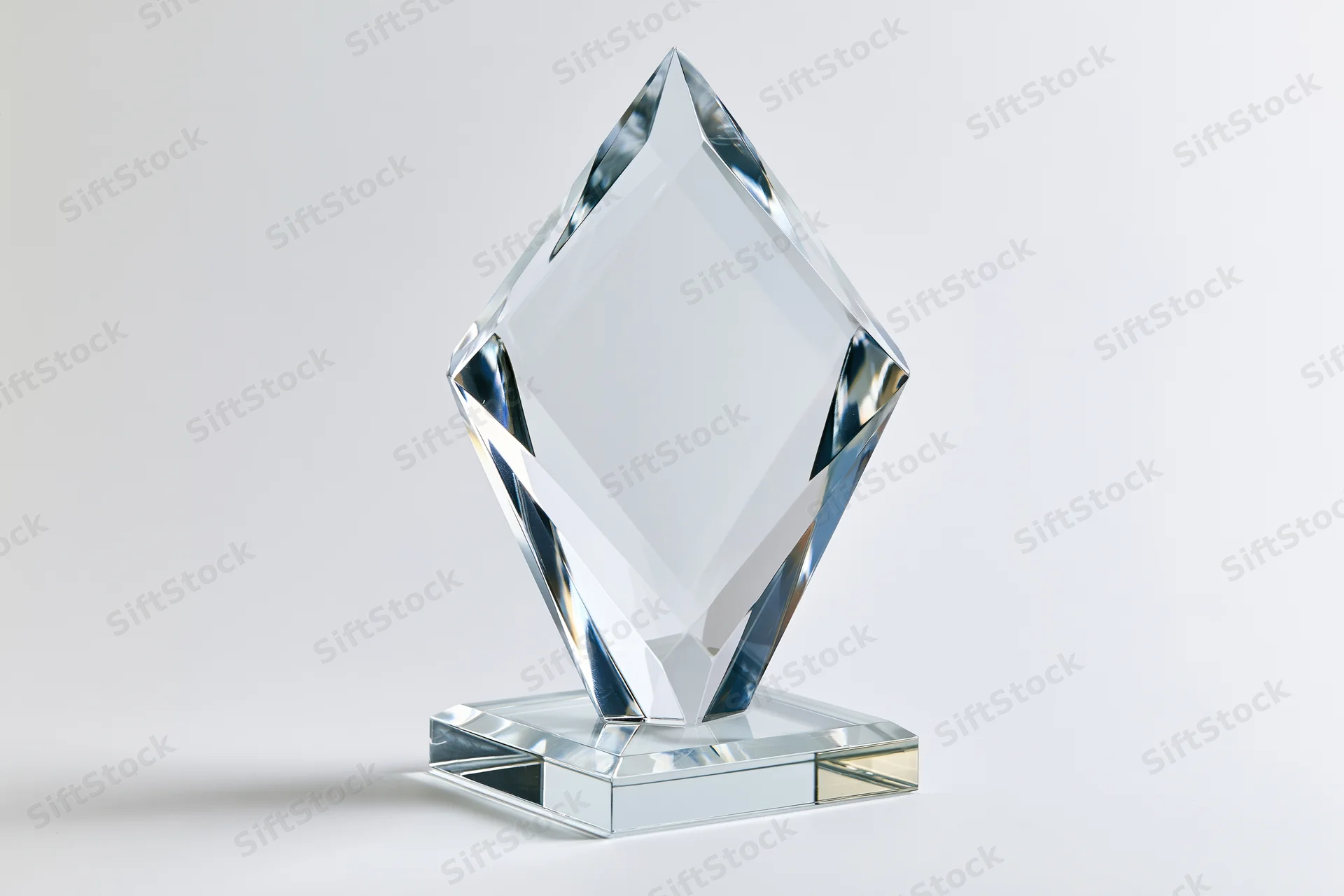 Blank crystal glass award trophy standing upright on a small base against white background