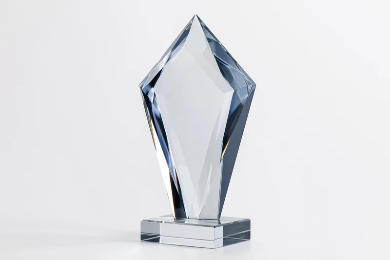 Blank crystal glass award trophy standing upright on a small base against white background