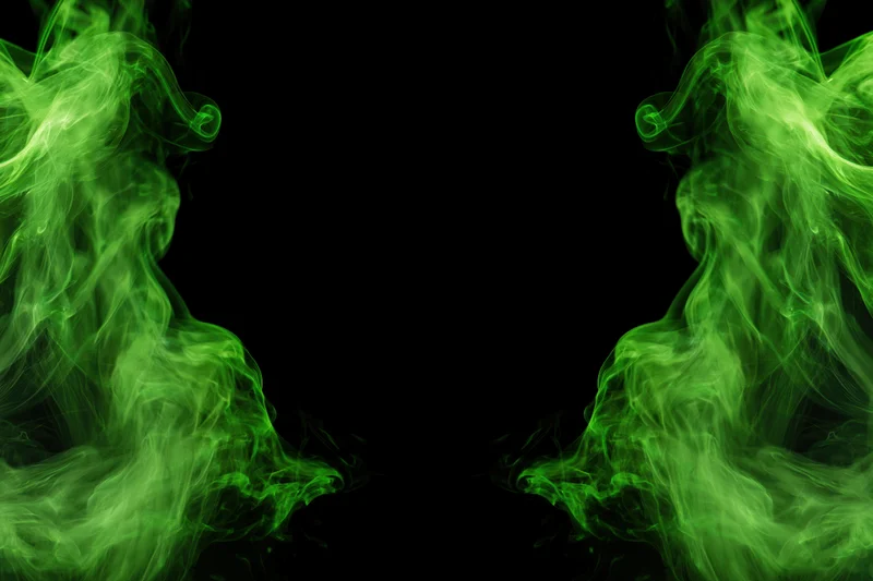 Neon green smoke wisps rising from both lower corners against black background