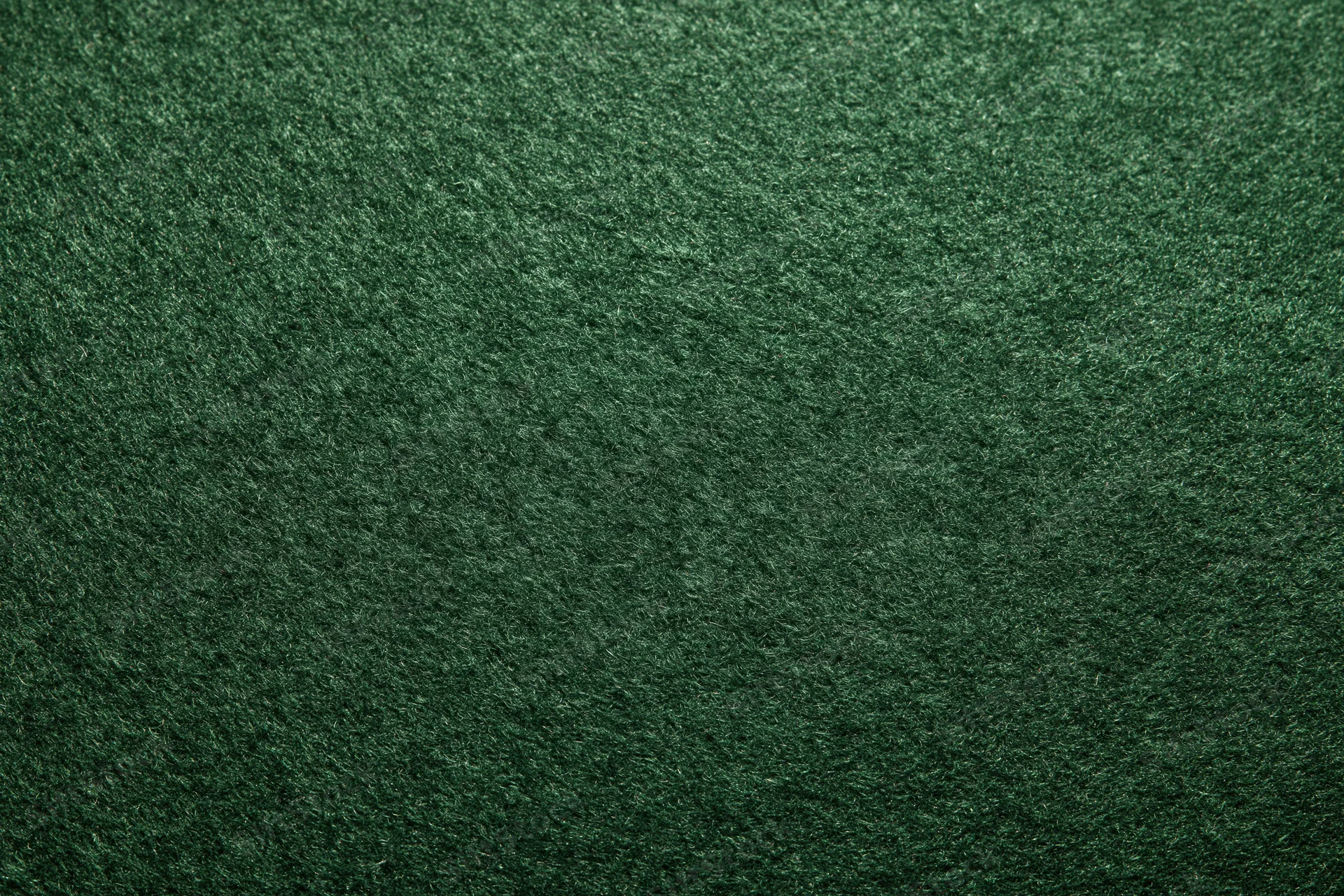 Dark forest green felt fabric in flat lay closeup showing texture and surface detail