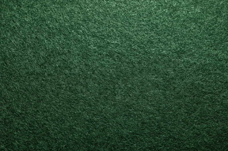 Dark forest green felt fabric in flat lay closeup showing texture and surface detail