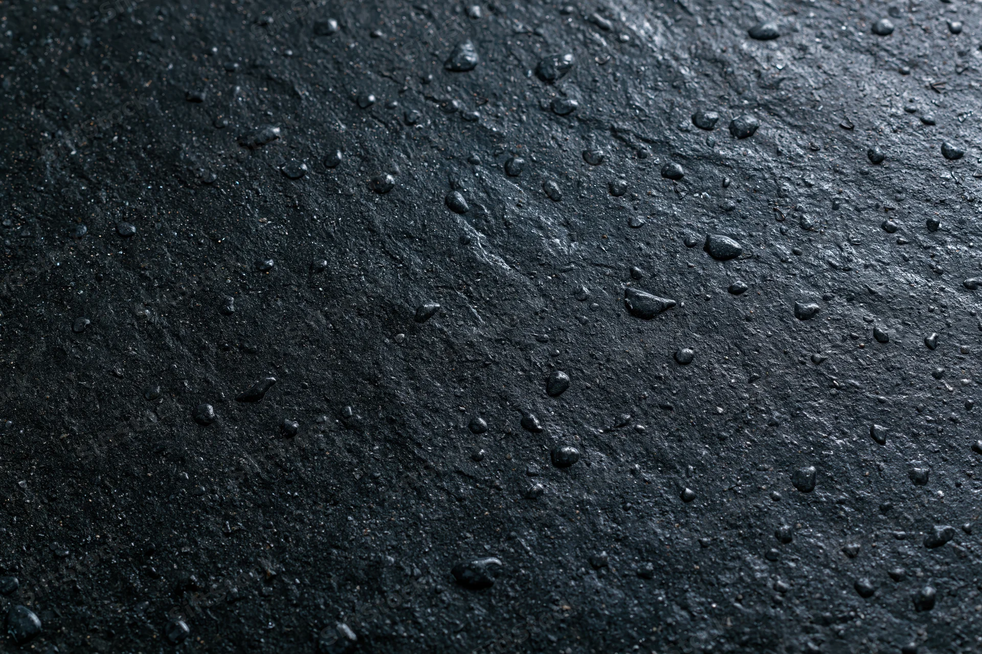 Wet dark concrete surface with water droplets in flat lay closeup