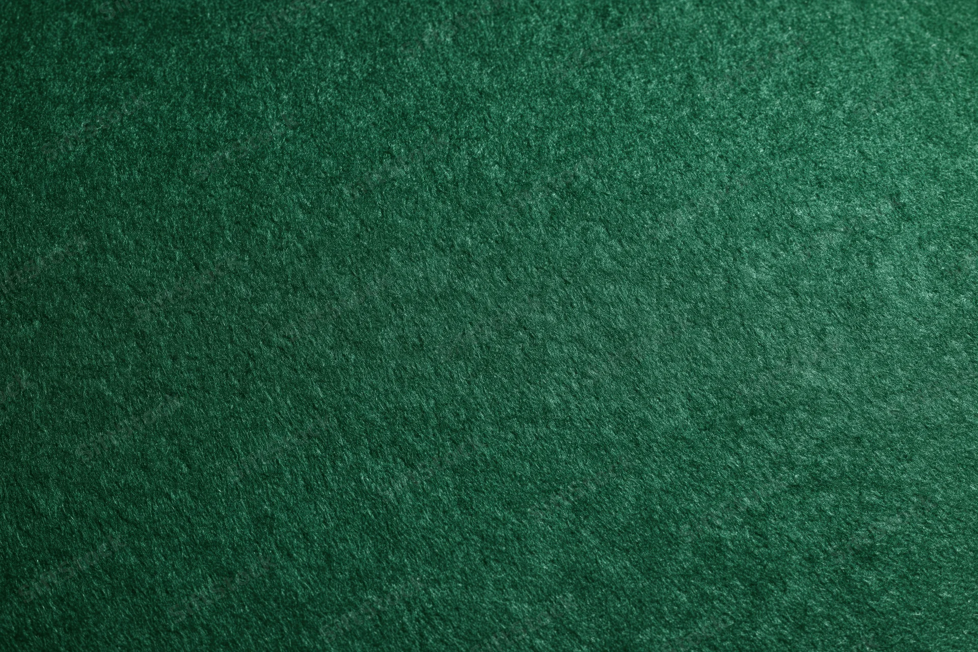 Close-up flat lay of deep forest green felt surface