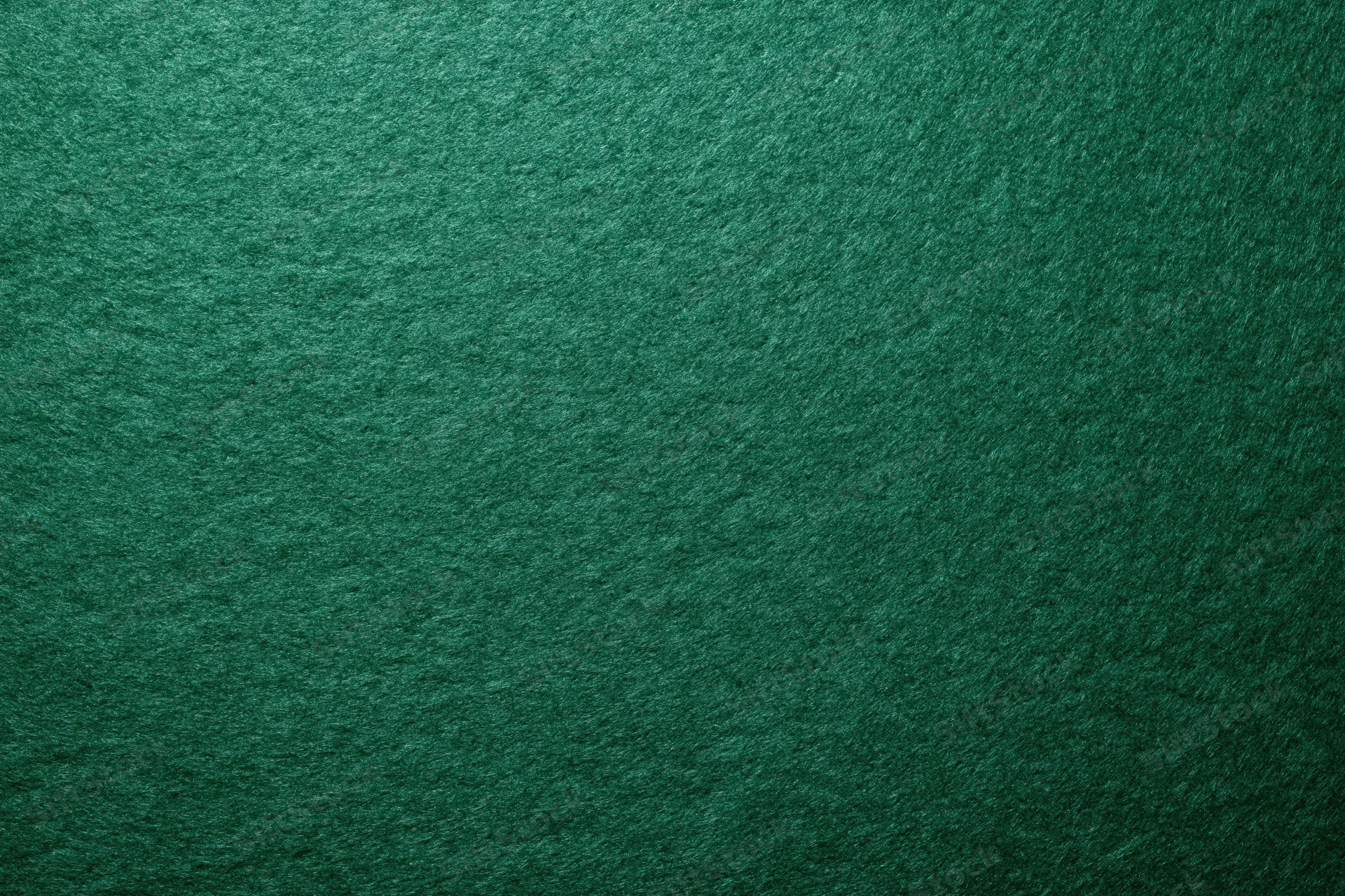 Close-up flat lay of deep forest green felt surface