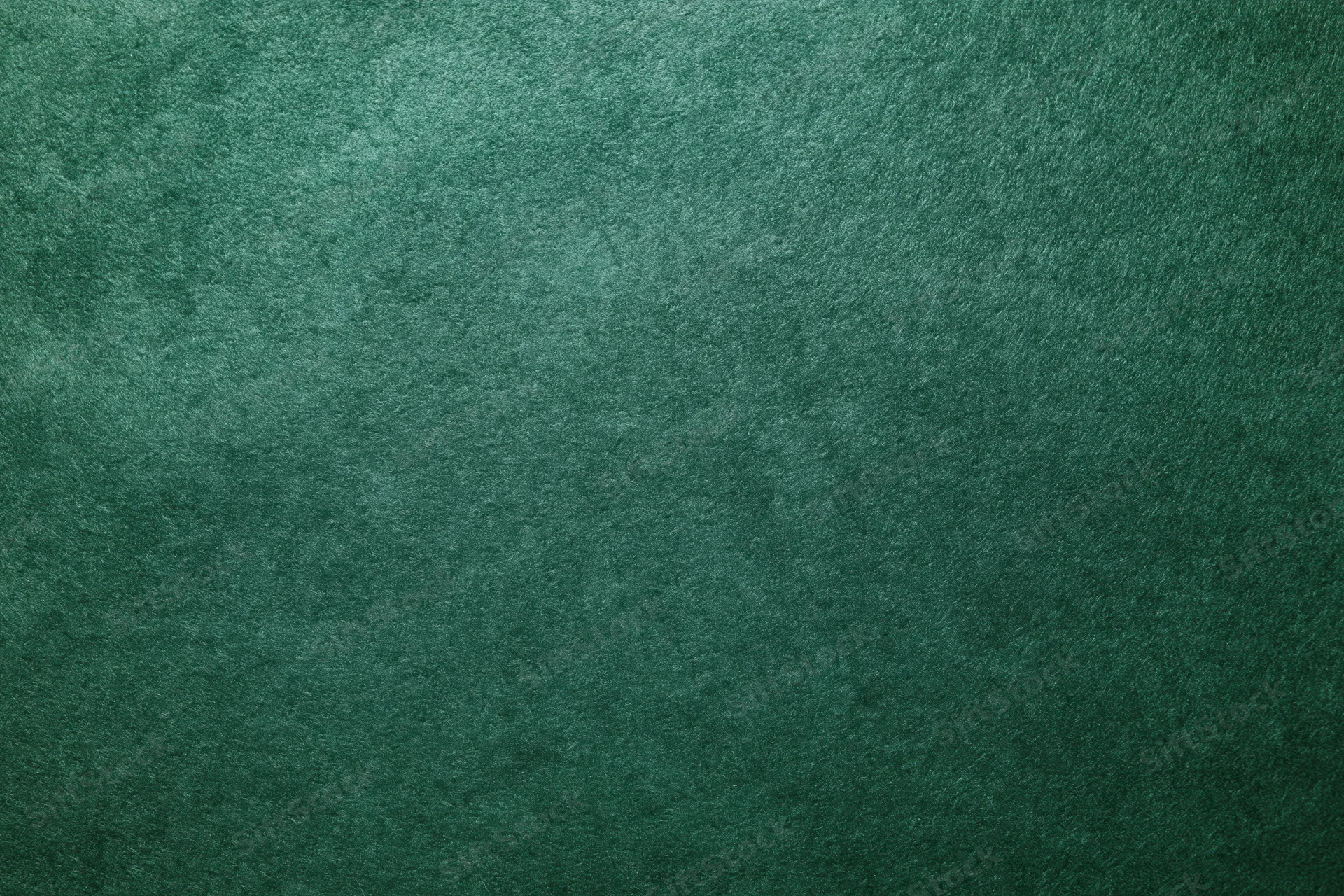 Close-up flat lay of deep forest green felt surface