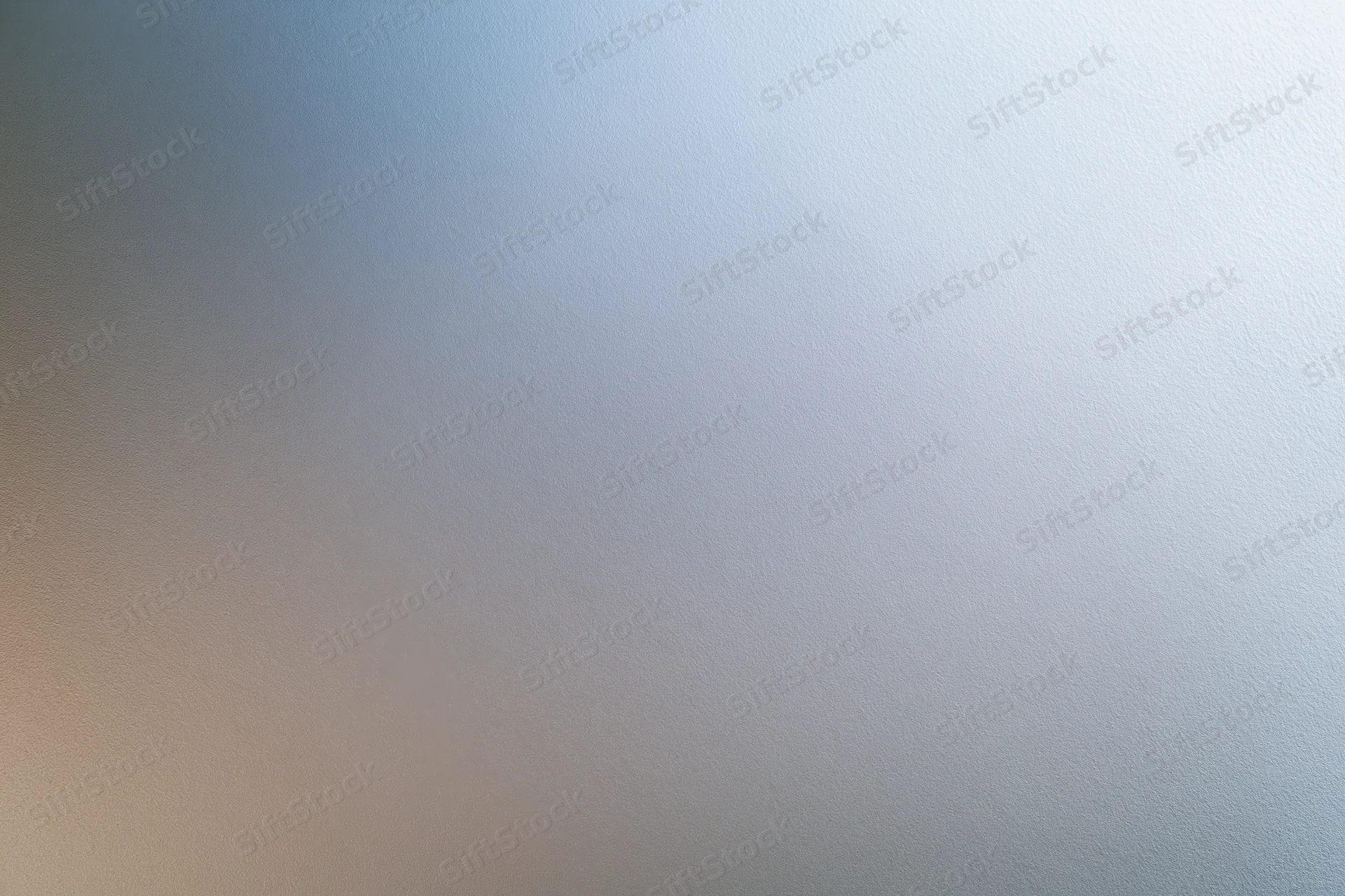 Close-up of a frosted glass or brushed metal surface with a smooth gradient texture