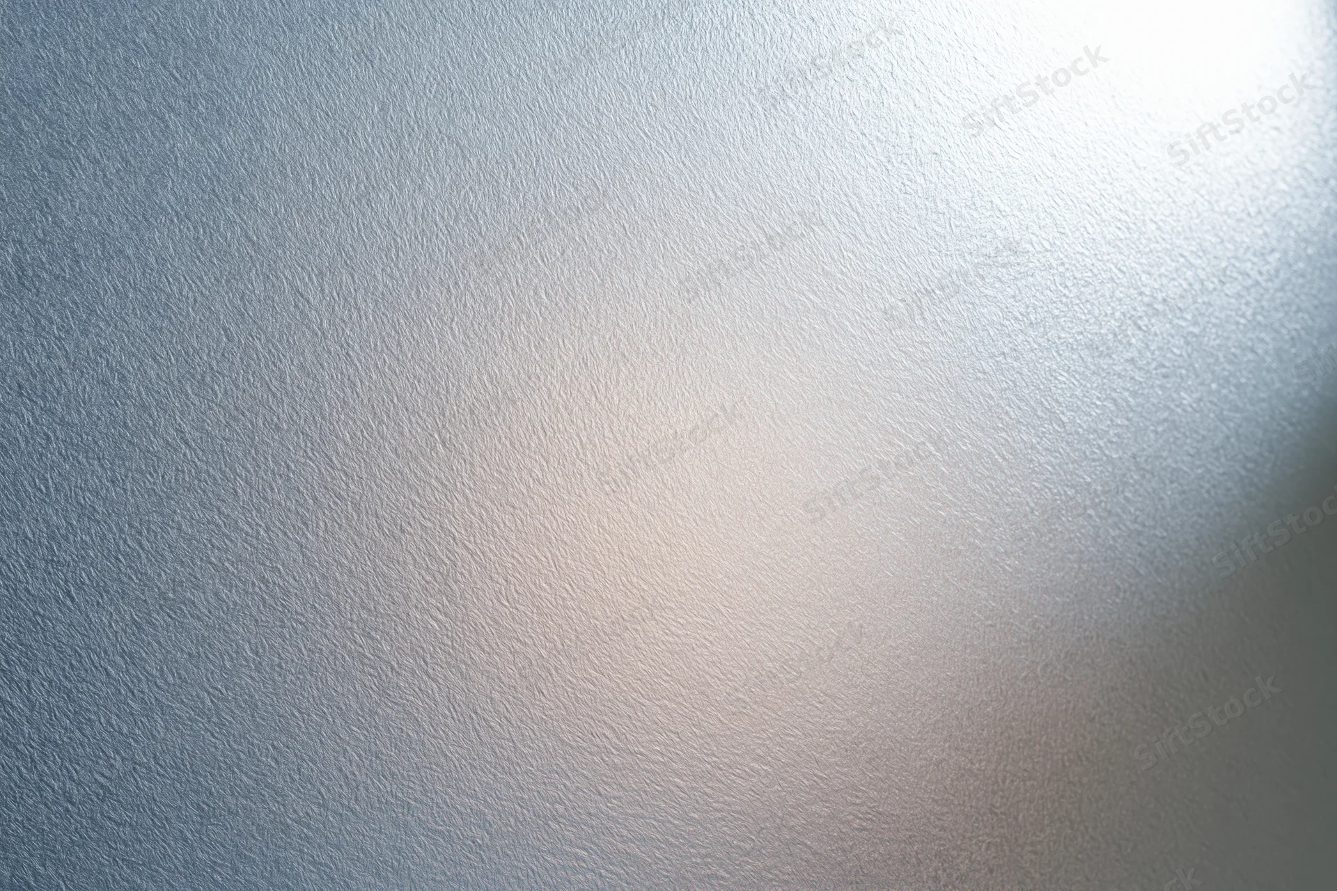 Close-up of frosted glass surface with soft light gradient and subtle texture