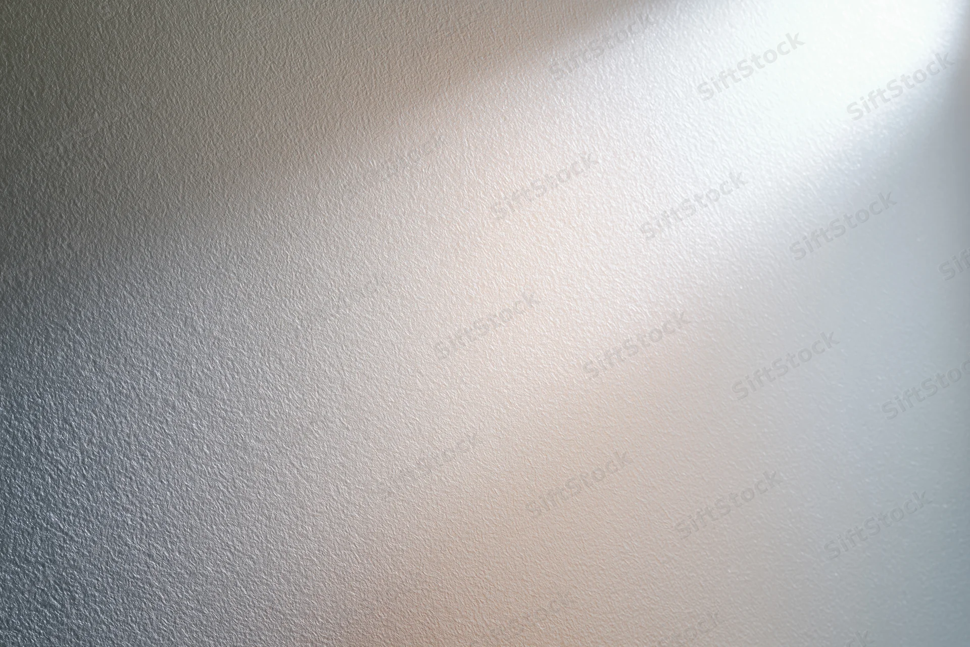 Close-up of frosted glass surface with soft light gradient and subtle texture