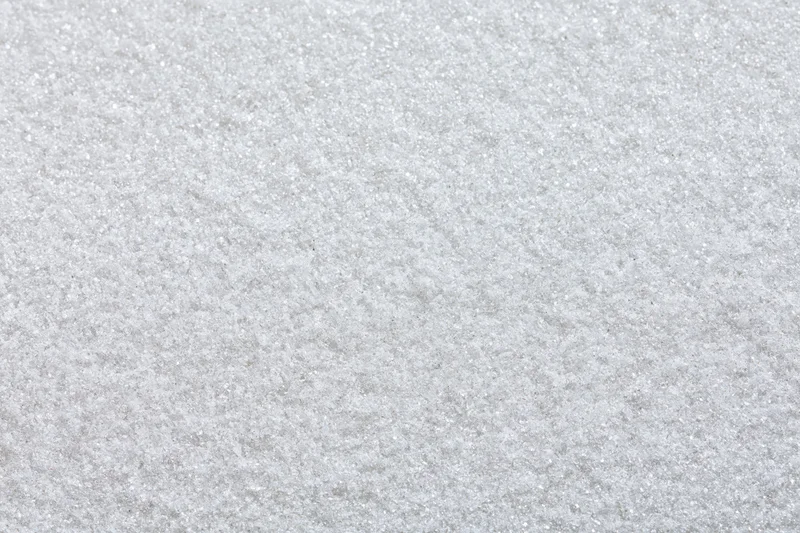 Close-up flat lay of a frosted white metal surface with textured grain pattern