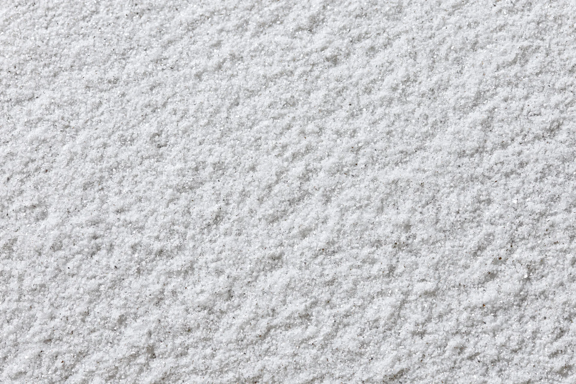 Close-up of a white galvanized metal surface with textured finish