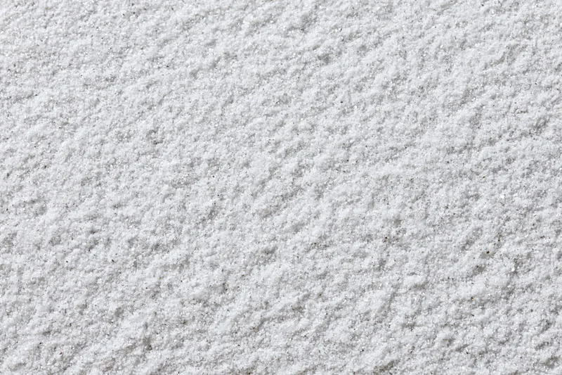 Close-up of a white galvanized metal surface with textured finish