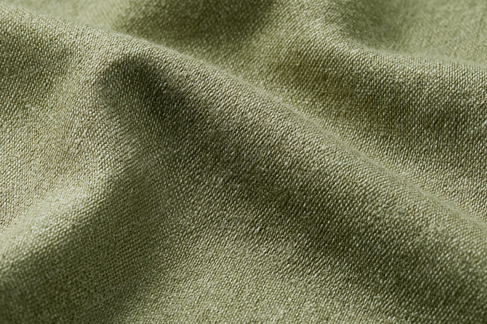 Close-up of muted olive green woven fabric surface in flat lay arrangement