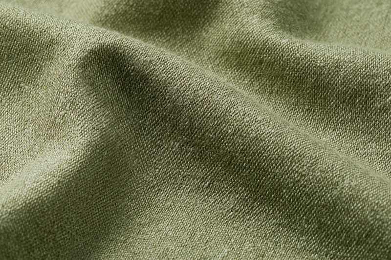 Close-up of muted olive green woven fabric surface in flat lay arrangement