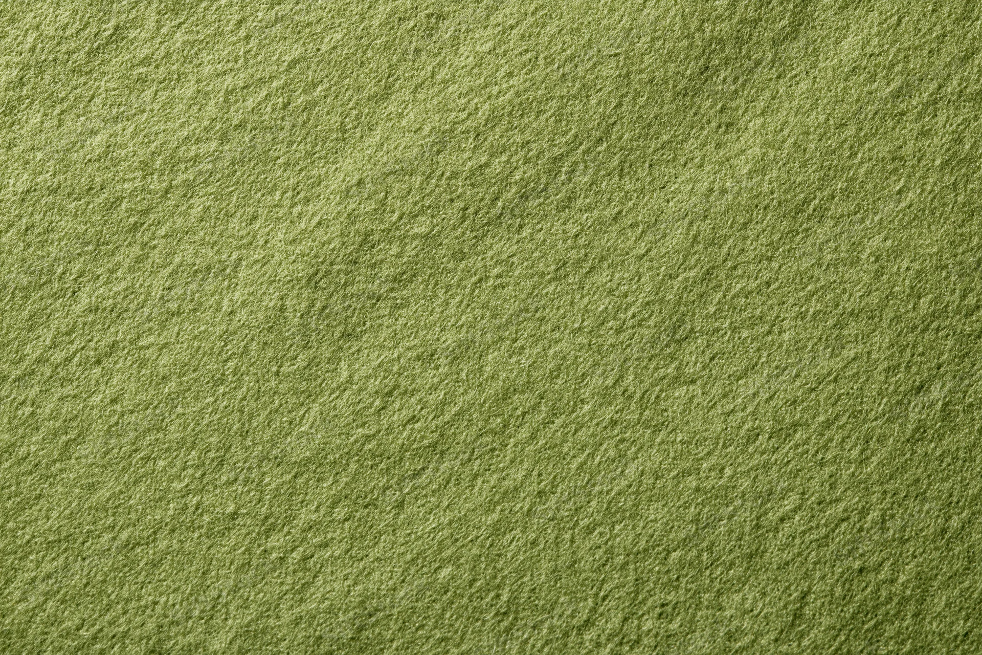 Close-up flat lay of muted olive green fabric surface filling frame