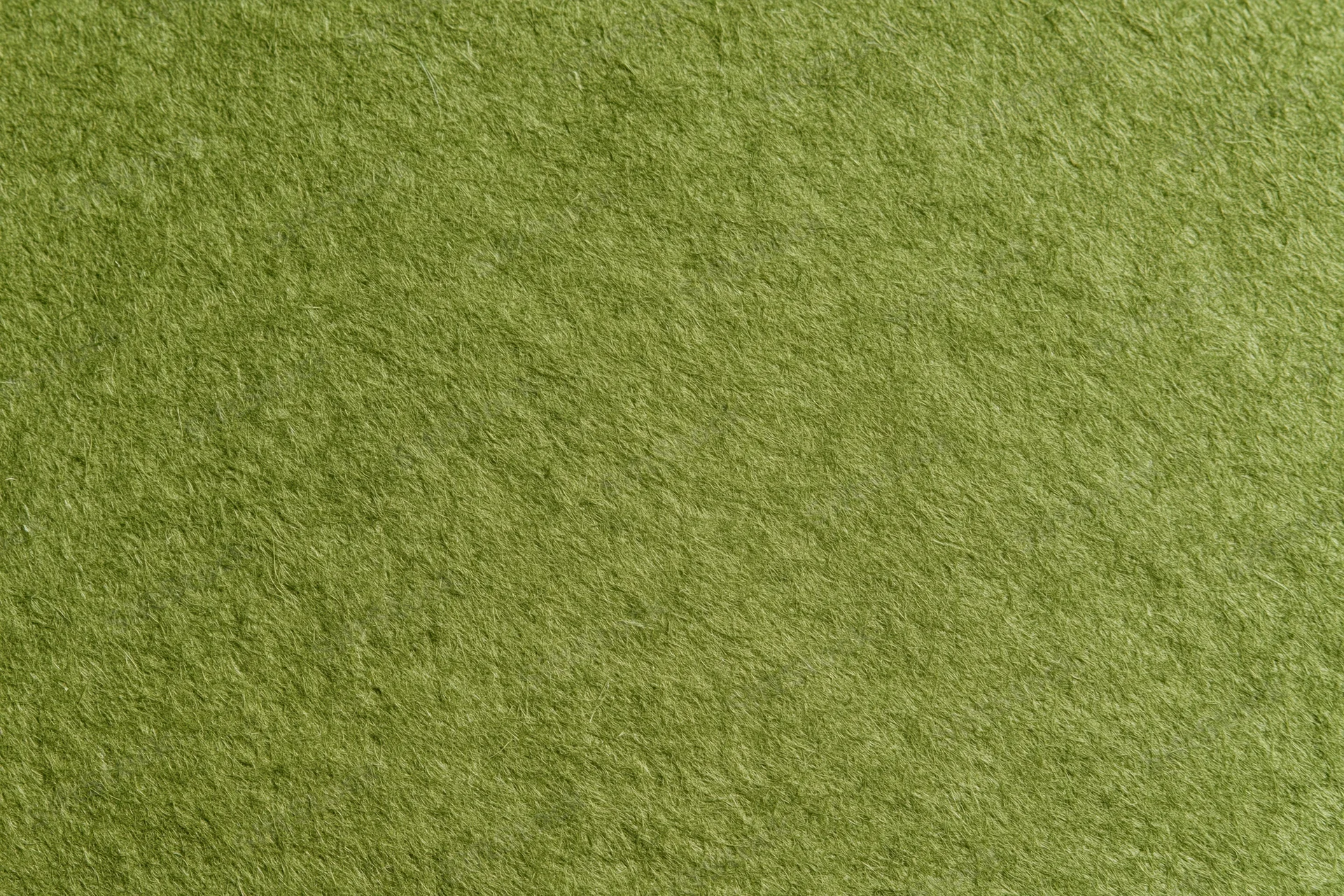 Close-up flat lay of plain olive green fabric surface