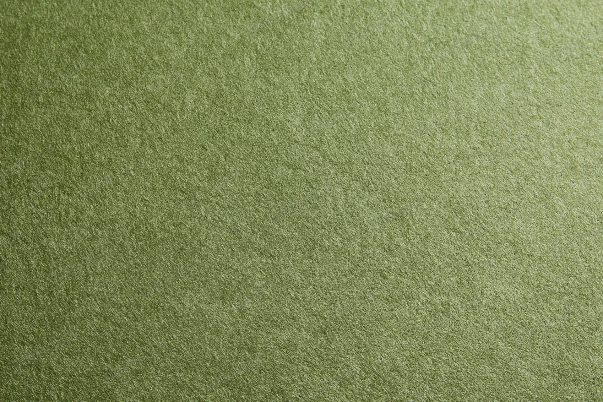Close-up flat lay of plain olive green fabric surface