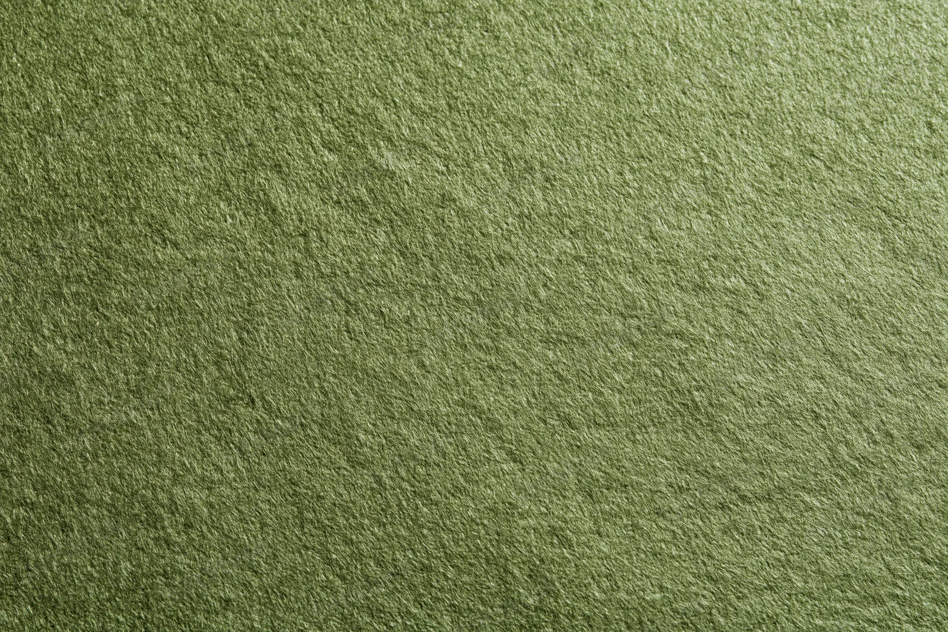 Close-up flat lay of plain olive green fabric surface