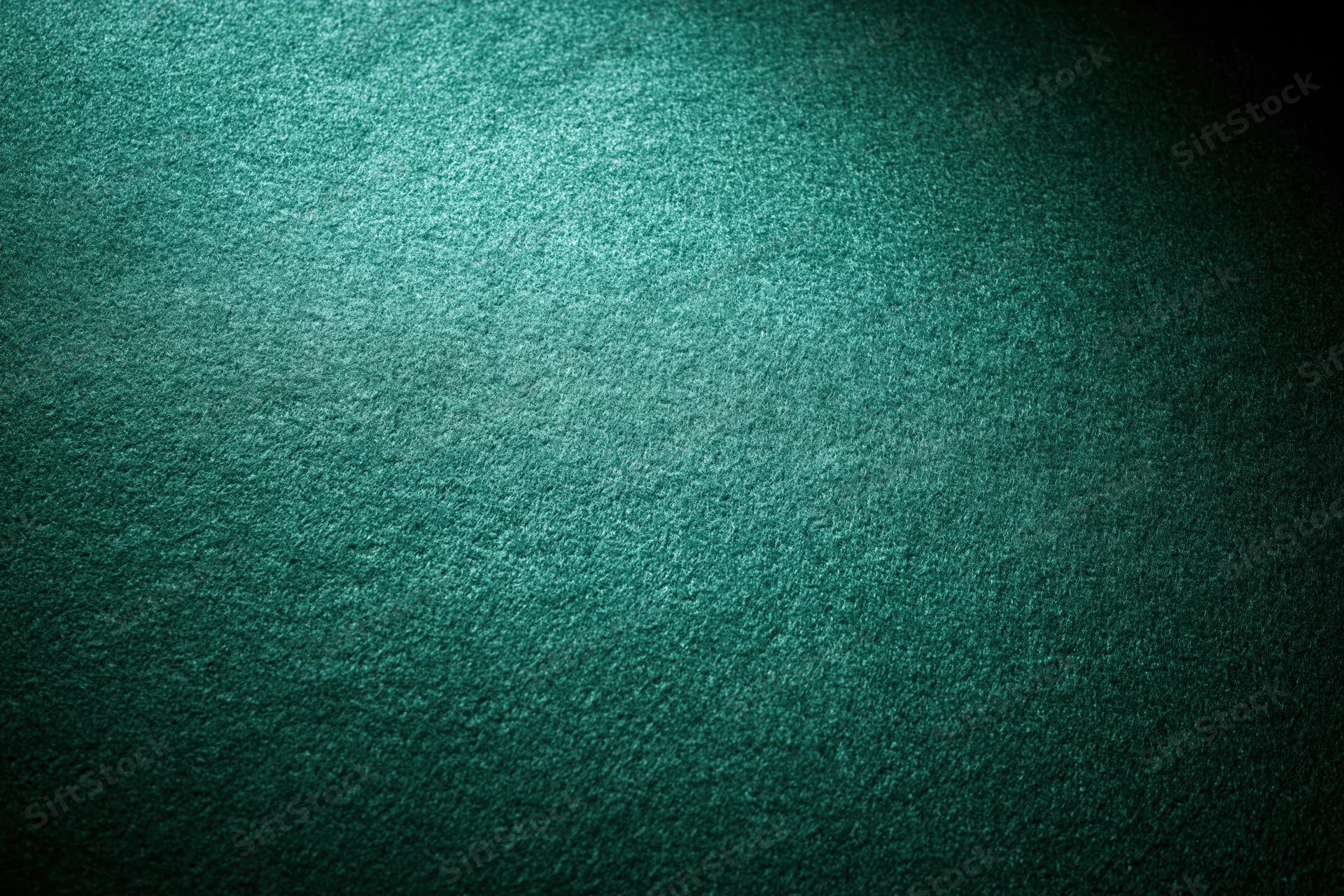 Close-up flat lay of green poker table felt surface