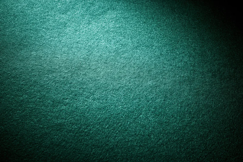 Close-up flat lay of green poker table felt surface