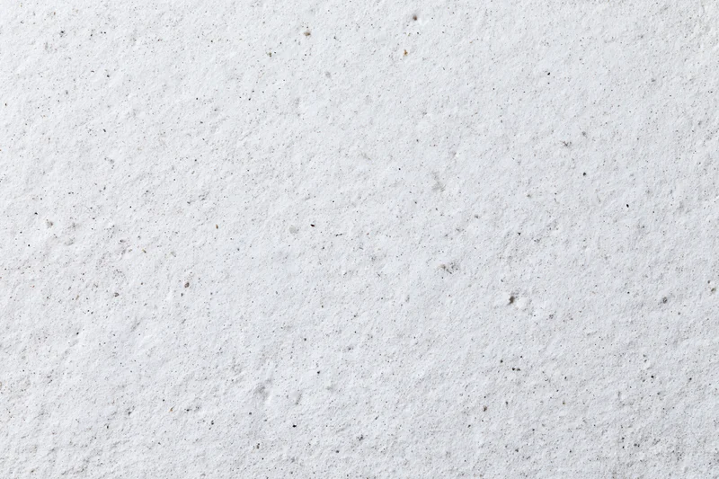 Close-up of a rough white concrete plaster wall surface