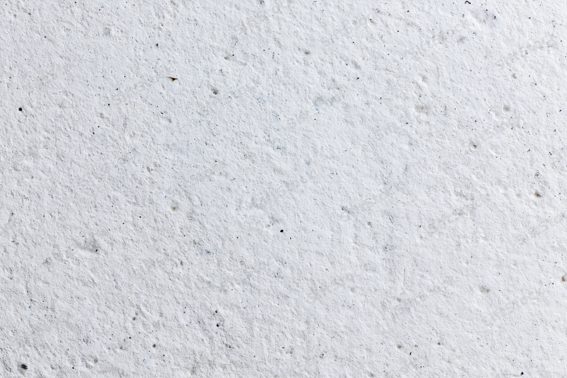 Close-up of a rough white concrete plaster wall surface