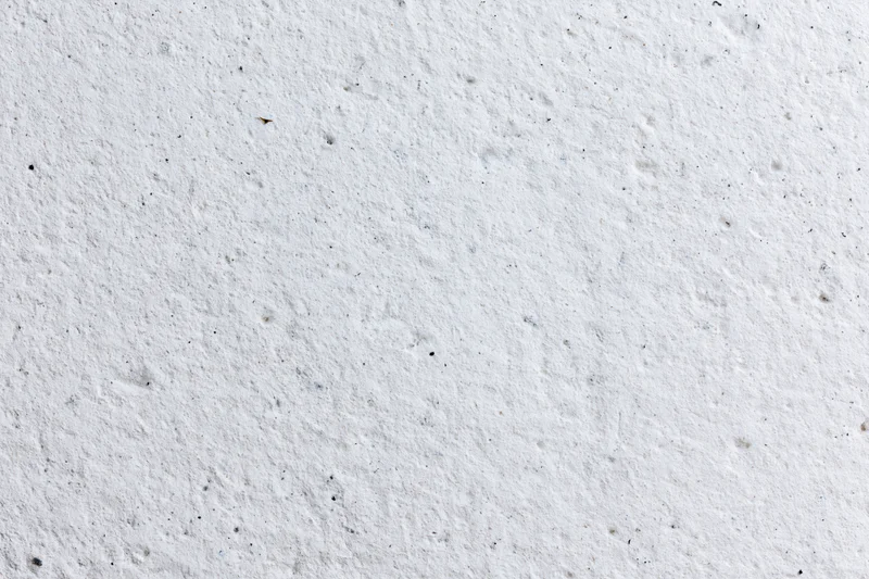 Close-up of a rough white concrete plaster wall surface